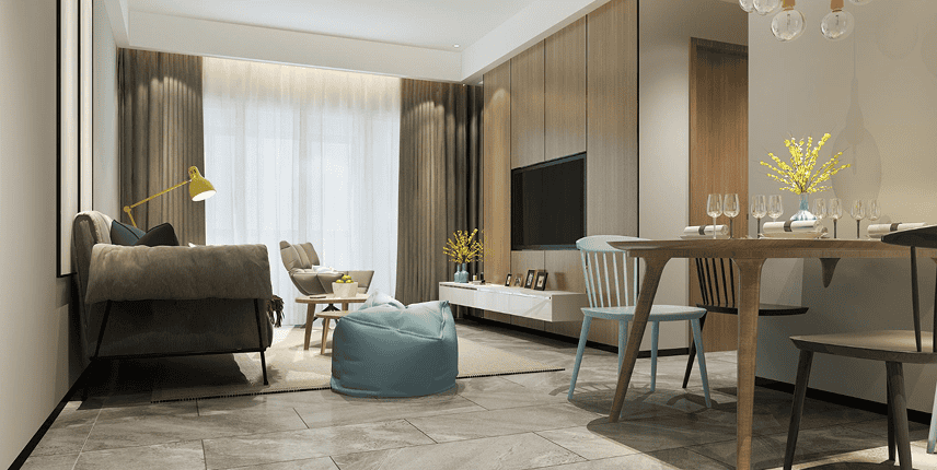 Modern living and dining room with neutral tones, a gray sofa, blue bean bag, wooden table and chairs, wall-mounted TV, large window with curtains, and decorative yellow flowers.